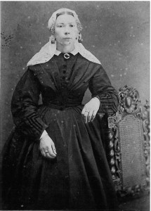 Vrouw in modejapon met lange muts ca 1880.